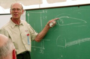 Chris Heintz explaining aerodynamics in front of a chalkboard.